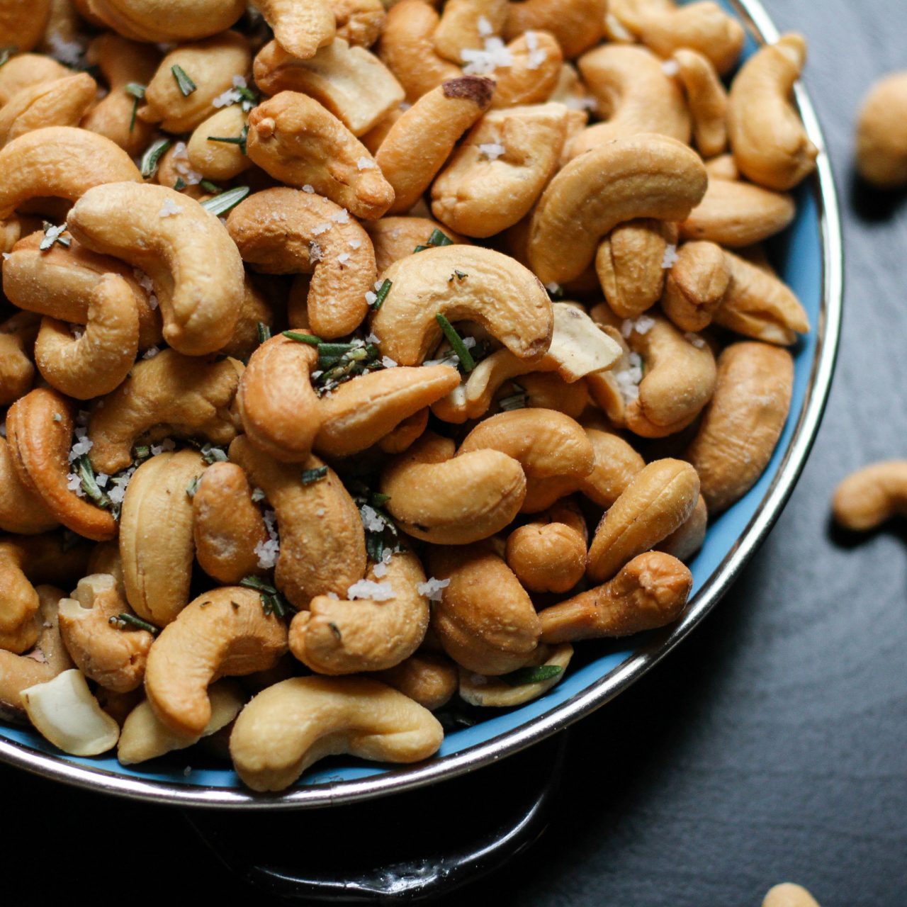 Cashews on a plate on dark background cold snacks